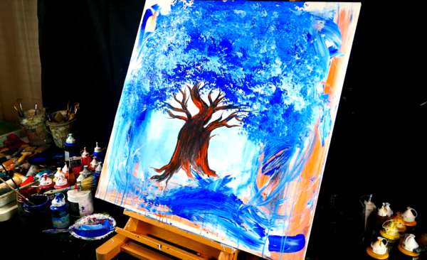 Painting orange tree trunk and blue leaves on abstract background