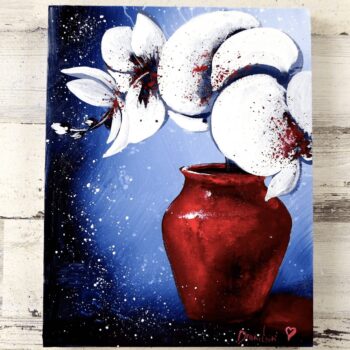 white orchid flowers in beautiful red vase