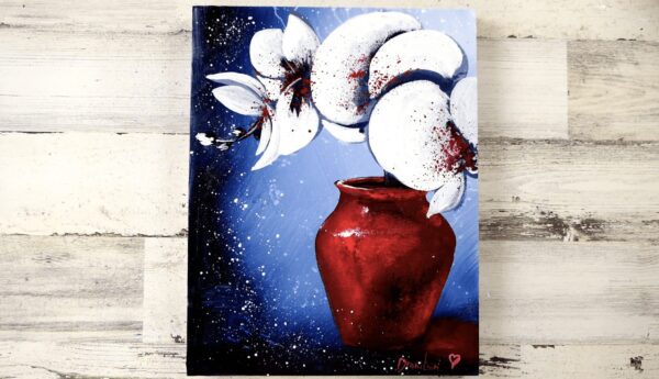 white orchid flowers in beautiful red vase